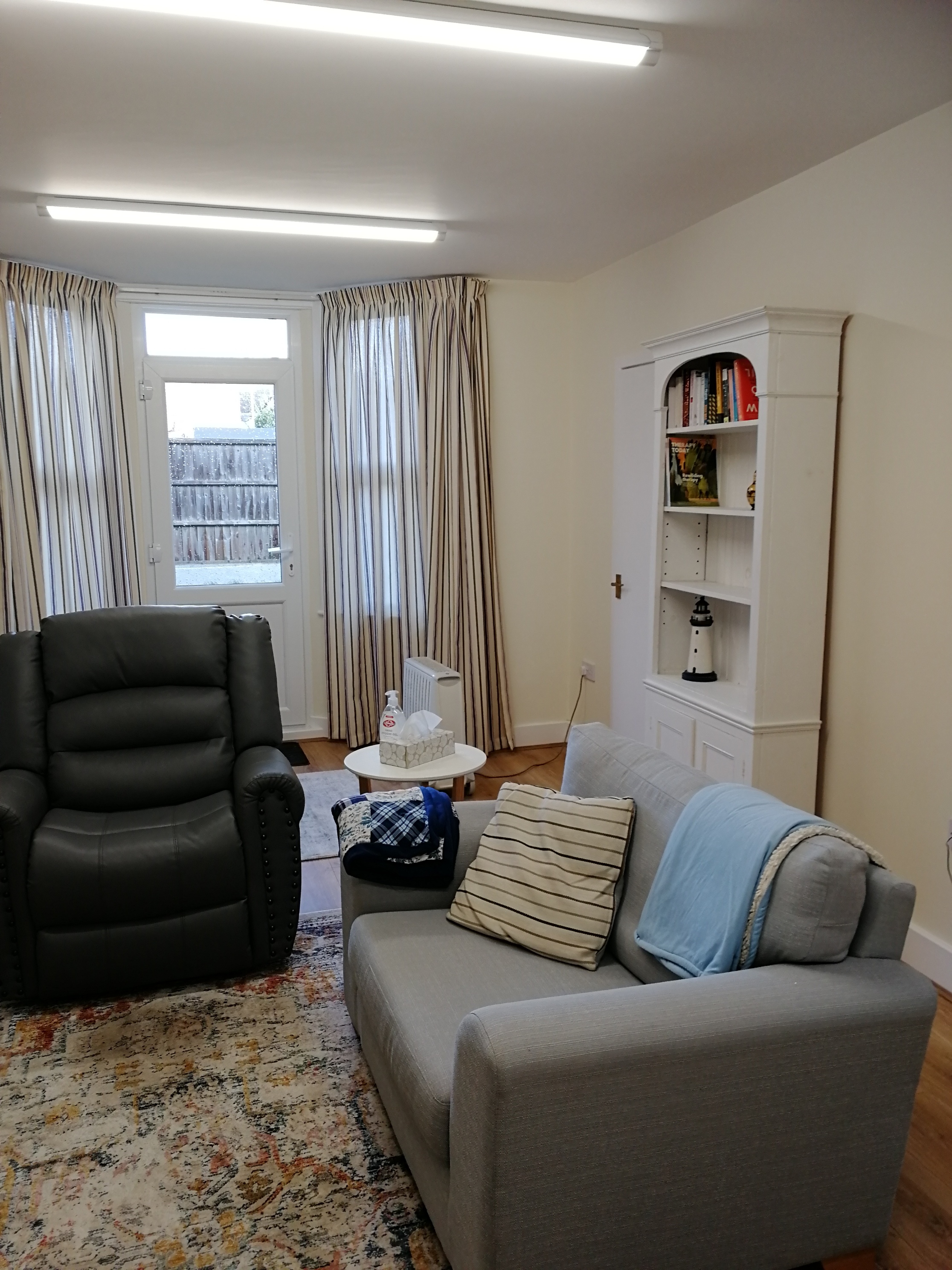 Therapist room with comfy chair and sofa